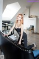 A woman sitting on top of a black couch.