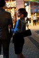 A man and a woman standing next to each other on a sidewalk.